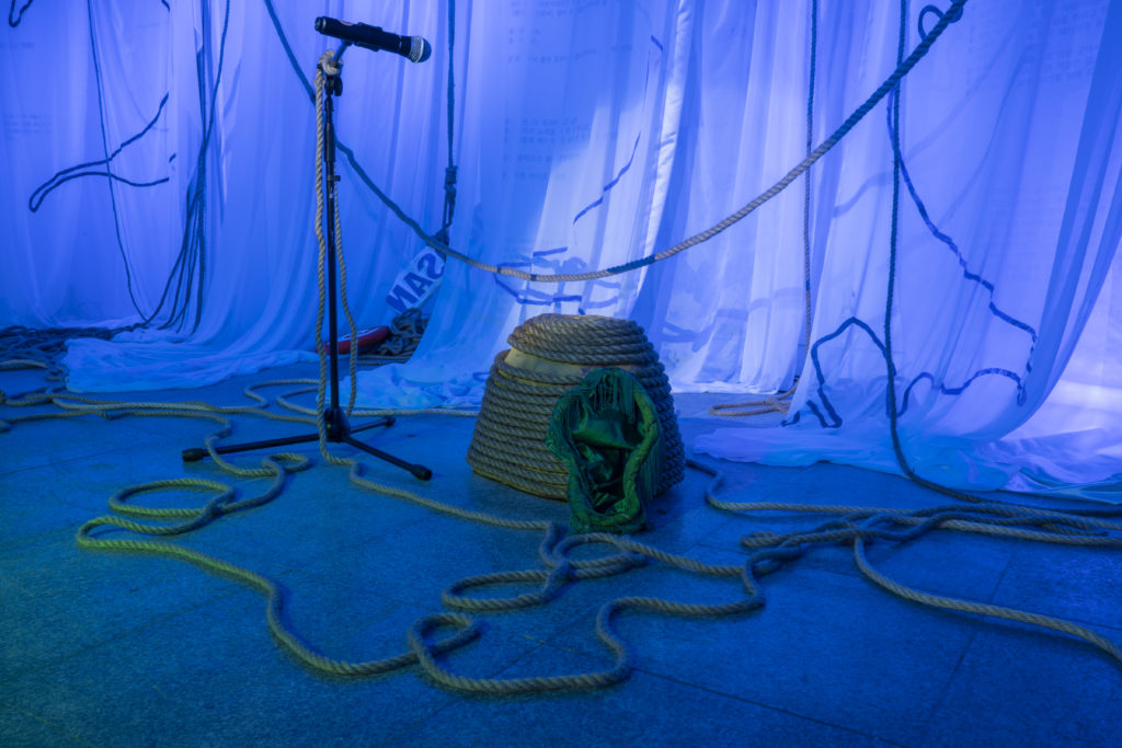 "Ecotone: Capacity for Escape" Interpermeations, 2022, performance, sound, audio programming, microphones, text, digital printing on fabric, acrylic on fabric, acrylic on sculpted XPS, mixed media costume sculpture, Manila rope. Installation shot by Seungwook Yang.